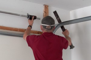 Slide garage door torsion springs off shaft.