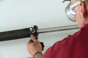 Check winds of garage door torsion springs.